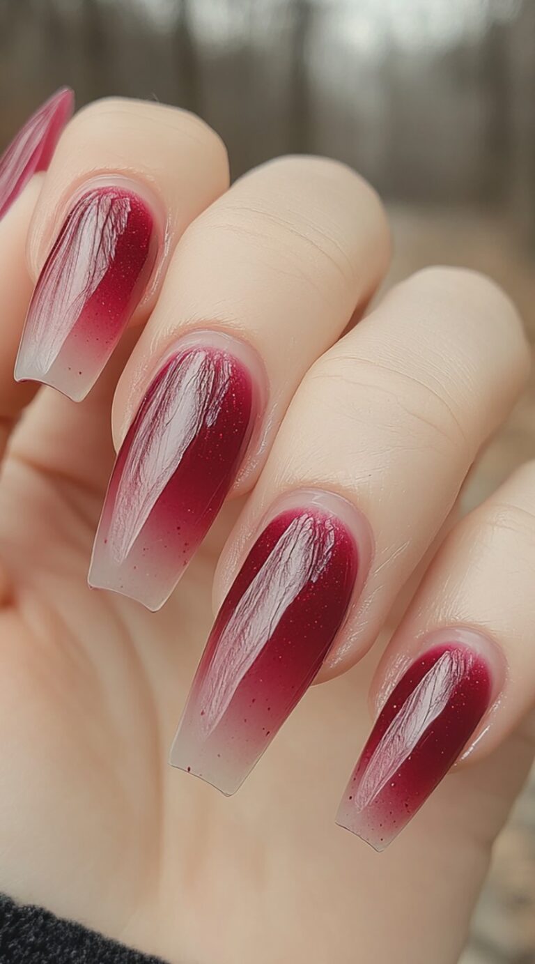 Glossy coffin nails fade from a clear base into a deep red wine hue with a high-shine finish.