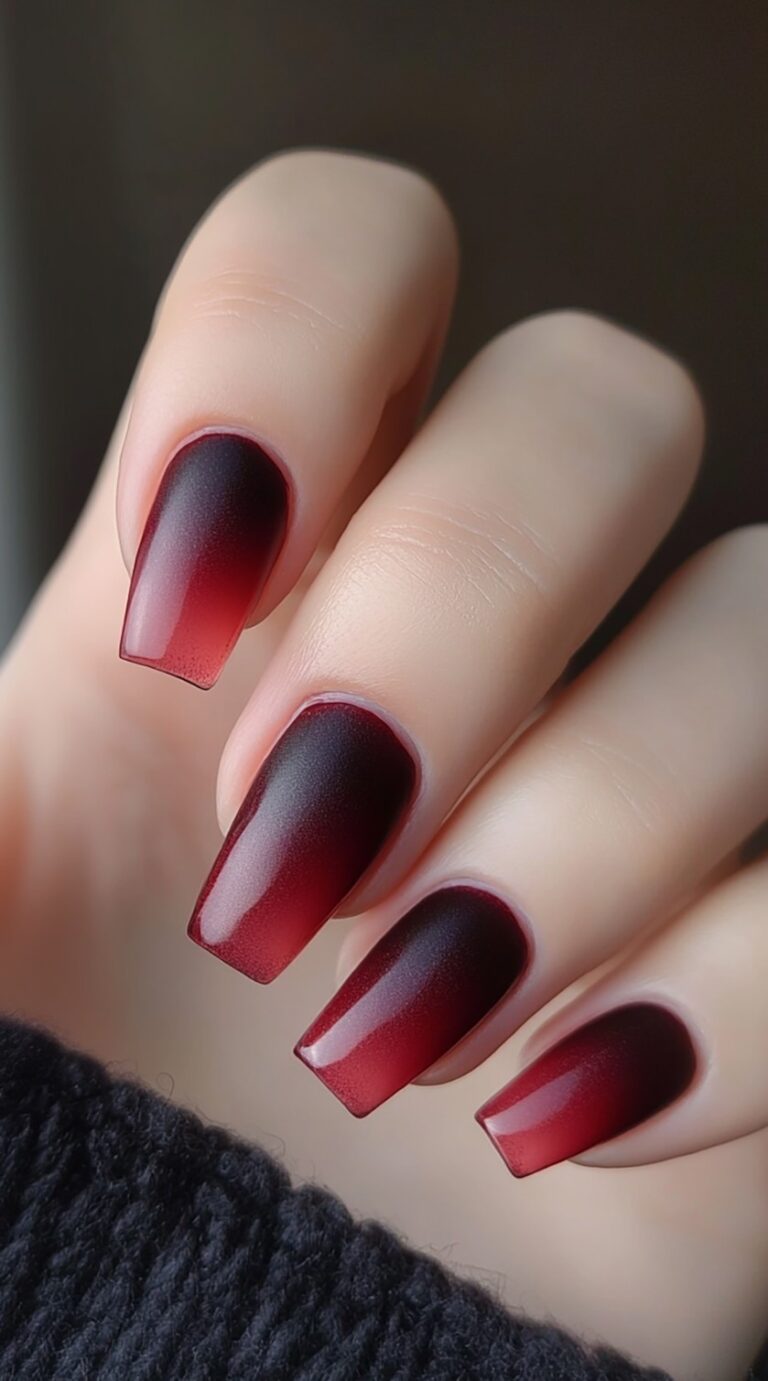 Medium-length coffin nails transition from a rich cherry red to black, topped with a matte finish.