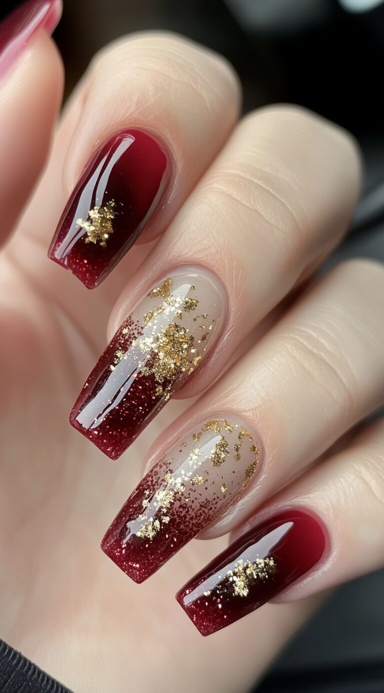 Tapered square nails feature a red glitter ombre base enhanced by scattered gold foil accents.